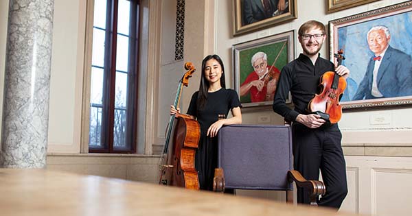 Belle Ra and James Marshall ’21E (MM) posing with their instruments