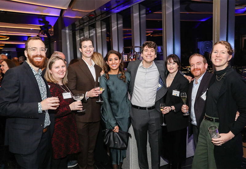 Group posing for photo at reception event